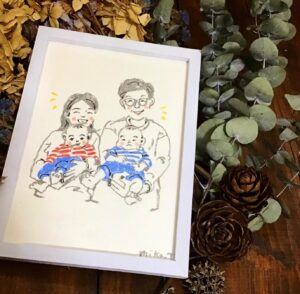 双子の赤ちゃんを抱いているが家族の絵